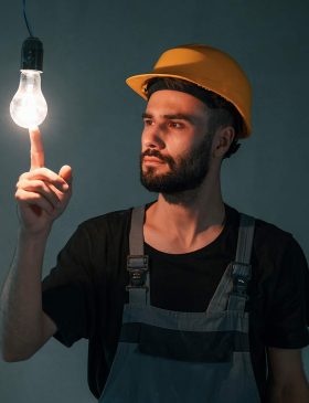 electrical estimating services provider holding a bulb